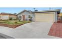 Street view of a one-story house with a large concrete driveway leading to an attached garage at 4102 Calimesa St, Las Vegas, NV 89115