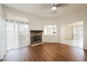 Bright living room with wood floors and a stone fireplace, showcasing the home's open floor plan at 430 Nancy Dr, Henderson, NV 89015