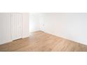 Large living room with hardwood floors and white walls at 4941 River Glen Dr # 4, Las Vegas, NV 89103