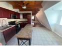 Bright kitchen featuring a breakfast bar, stainless steel appliances, and wood-beamed ceiling at 6171 Whispering Sands Dr, Las Vegas, NV 89131