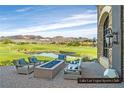 Beautiful back patio with a fire pit and golf course views with a lake at 64 Strada Principale # 307, Henderson, NV 89011