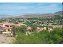 Expansive neighborhood view showing a collection of homes nestled against a mountainous landscape at 64 Strada Principale # 307, Henderson, NV 89011