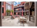 Inviting courtyard with stylish outdoor seating, umbrellas and charming architectural details at 64 Strada Principale # 307, Henderson, NV 89011