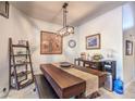 Cozy dining area featuring a modern chandelier, dining table, and stylish decor at 7131 Mission Hills Dr, Las Vegas, NV 89113
