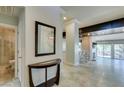 View of the home's entryway with a tiled floor, a hall table and a bathroom at 7131 Mission Hills Dr, Las Vegas, NV 89113