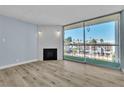 Bright living room featuring wood flooring, modern light-blue paint, and a fireplace with sliding glass doors to the balcony at 725 N Royal Crest Cir # 237, Las Vegas, NV 89169
