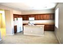Spacious kitchen with wooden cabinetry, kitchen island and appliances at 8348 Mokena Ave, Las Vegas, NV 89178
