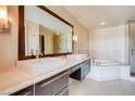 Bright bathroom featuring double sinks, drawers and a luxurious soaking tub next to a glass-door shower at 8925 W Flamingo Rd # 310, Las Vegas, NV 89147