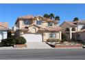Inviting two-story home with a terra cotta tile roof, a well-manicured lawn and a two car garage at 8982 Emerald Waters Ct, Las Vegas, NV 89147