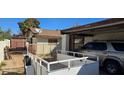 Exterior view of a single-story home with a carport, trailer, and storage shed in the background at , Las Vegas, NV 89103