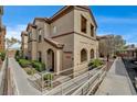Complex exterior featuring stucco finish, arched entryways, and accessible ramp at 10270 Gilmore Canyon Ct # 202, Las Vegas, NV 89129