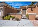 Charming front entrance with gated courtyard and manicured landscaping at 10640 Mission Lakes Ave, Las Vegas, NV 89134