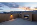 Cozy rooftop patio includes a modern fireplace feature and scenic mountain views at 10729 Red Badge Ave, Las Vegas, NV 89166