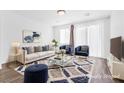 Cozy living room featuring modern furnishings, a stylish rug, and ample natural light at 10946 Mount Goyer St, Las Vegas, NV 89141