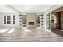 Modern living room with a fireplace, floating shelves, and a sliding glass door leading to a stone patio at 11280 Granite Ridge Dr # 1101, Las Vegas, NV 89135