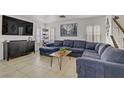 Bright living room with comfortable seating, plantation shutters, and a large television at 1131 Orange Meadow St, Las Vegas, NV 89142