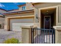 A beautiful front porch with a view of the two car garage and stone walkway at 1173 Scenic Edge St, Henderson, NV 89002