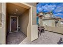 Cozy front porch sitting area with a small table, perfect for enjoying a morning coffee at 1173 Scenic Edge St, Henderson, NV 89002