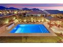 Elevated view showcases the sparkling pool, gazebo, backyard oasis, and surrounding neighborhood at 11878 Albissola Ave, Las Vegas, NV 89138