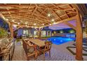 Inviting backyard features a sparkling pool, outdoor dining area with a grill, perfect for entertaining at 11878 Albissola Ave, Las Vegas, NV 89138