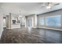 Spacious living room with gray walls, wood-look floors, and lots of natural light from multiple windows at 11890 Tevare Ln # 1098, Las Vegas, NV 89138