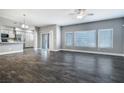 Open-concept living area with sliding glass doors, modern flooring and neutral gray color scheme at 11890 Tevare Ln # 1098, Las Vegas, NV 89138