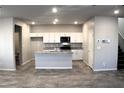 Modern kitchen with white cabinets, stainless steel appliances, granite countertops and a kitchen island at 12800 Oceano Dunes Ct, Henderson, NV 89044