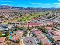 A drone shot shows this home's location on a cul-de-sac near golf course with mountain views at 1983 Songbird Ct, Henderson, NV 89012
