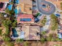 Aerial view of a single-Gathering home featuring a private pool, spa, and solar panels on the roof at 1983 Songbird Ct, Henderson, NV 89012