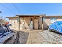 View of back exterior featuring covered patio, storage units, and ample parking at 2054 Harvard St, North Las Vegas, NV 89030