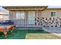 Inviting covered front porch with stone accents and decorative metal railings at 2054 Harvard St, North Las Vegas, NV 89030