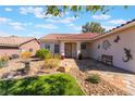 Lovely single-story home with a stone pathway leading to the front door and decorative yard art at 206 Lynbrook St, Henderson, NV 89012
