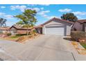 Beautiful single-story home showcasing a wide driveway and a well-manicured front yard at 206 Lynbrook St, Henderson, NV 89012