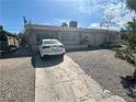 Charming single-story house with a gravel front yard and a clean, white car parked in the driveway at 2108 E Ogden Ave, Las Vegas, NV 89101