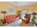Bright living room with peach walls, neutral carpet, and sliding glass doors to the exterior at 2110 Los Feliz St # 2064, Las Vegas, NV 89156