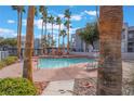 Enjoy the community pool surrounded by mature palm trees, providing a resort-style experience at 2201 Ramsgate Dr # 823, Henderson, NV 89074