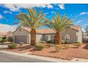 Beautiful single-story home with lush desert landscaping, tile roof, and well-maintained front yard at 2306 Valley Cottage Ave, Henderson, NV 89052