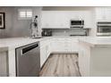 Modern kitchen featuring white cabinetry, stainless steel appliances, and sleek countertops with a stylish backsplash at 2306 Valley Cottage Ave, Henderson, NV 89052