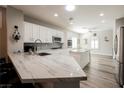 Bright kitchen with white cabinets, stainless steel appliances, quartz countertops, and a spacious center island at 2306 Valley Cottage Ave, Henderson, NV 89052