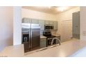 Well-lit kitchen featuring stainless steel appliances, gray cabinets, and a breakfast bar for modern living at 231 W Horizon Ridge Pkwy # 1011, Henderson, NV 89012