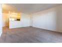 Expansive living room featuring neutral carpet, freshly painted walls, and a pass-through to the kitchen at 231 W Horizon Ridge Pkwy # 1011, Henderson, NV 89012