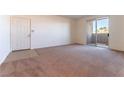 Inviting living room with plush carpeting and sliding glass doors that lead to a private balcony at 231 W Horizon Ridge Pkwy # 1011, Henderson, NV 89012