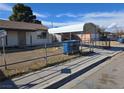 Charming single-story home with a secure chain-link fence and covered car parking at 2481 San Marcos St, Las Vegas, NV 89115