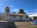 Modest single-story home with a secure chain-link fence and covered car parking at 2481 San Marcos St, Las Vegas, NV 89115