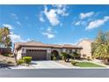 Well-maintained single-story home with tile roof, two-car garage, and manicured desert landscaping at 2665 Chateau Clermont St, Henderson, NV 89044