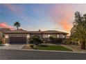 Inviting single-story home with a tile roof, arched entryway, and desert-style front yard under evening sky at 2665 Chateau Clermont St, Henderson, NV 89044