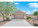 Single-story home with desert landscaping, well-maintained lawn, and two-car garage at 2709 Rue Montpellier Ave, Henderson, NV 89044