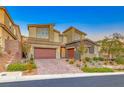 Beautiful two-story home boasting a three-car garage and a well-maintained, landscaped front yard at 28 Vista Outlook St, Henderson, NV 89011