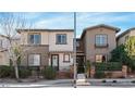 View of a neighborhood street featuring well-maintained townhomes with inviting entrances and landscaping at 3185 Mura Del Prato Ave, Henderson, NV 89044