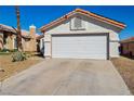 Single-story home showcasing a well-kept two-car garage and desert-style landscaping at 4130 Lucas Ave, Las Vegas, NV 89120